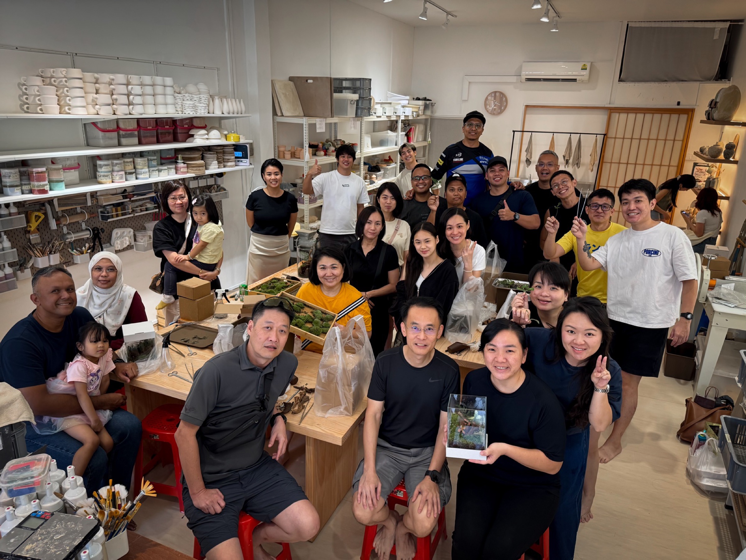 A corporate team with the terrariums they built at Chai Chee Safari
