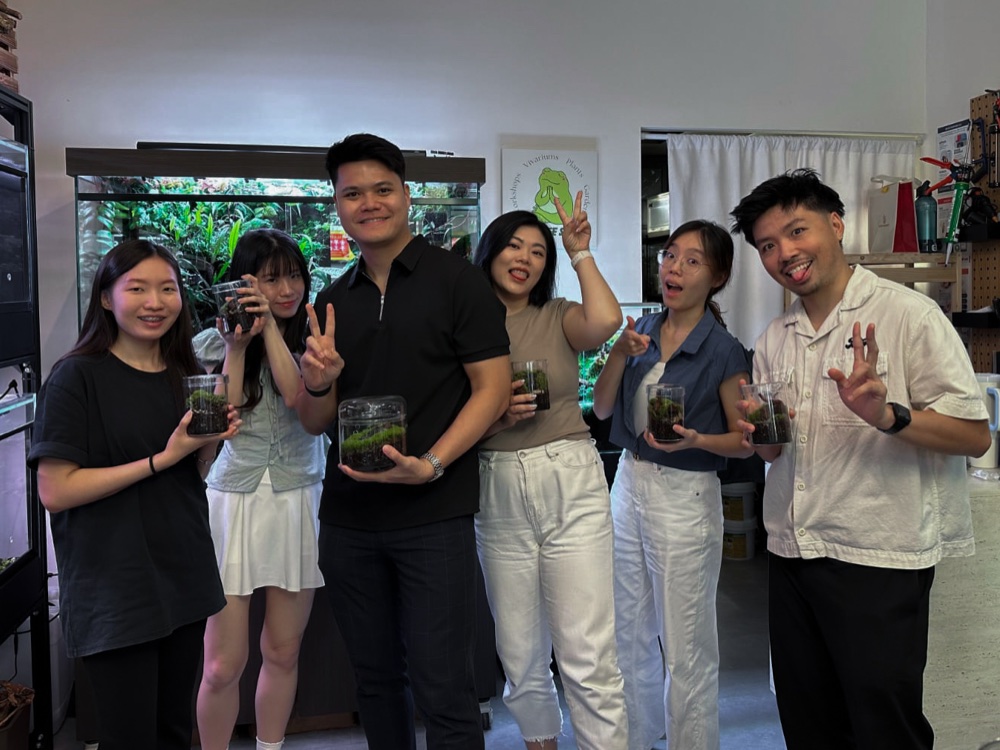 A team showing off the terrariums they made