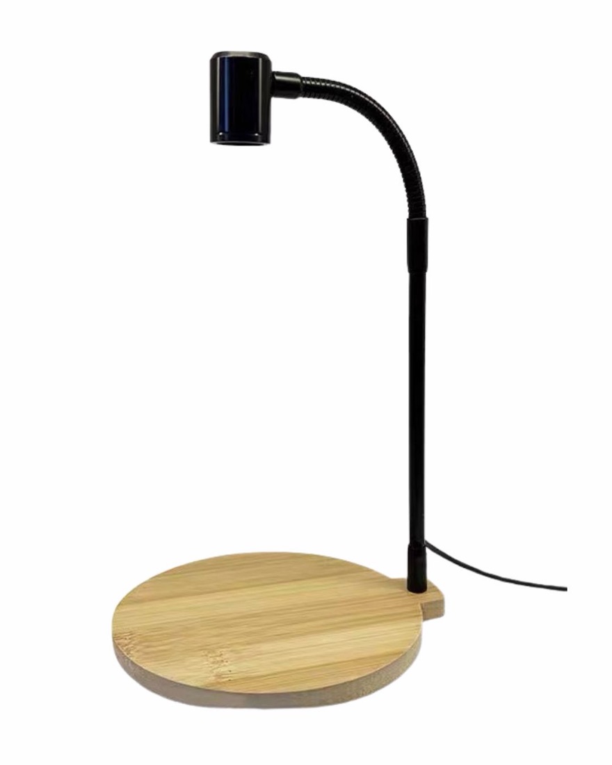 A small LED grow light on a bamboo stand